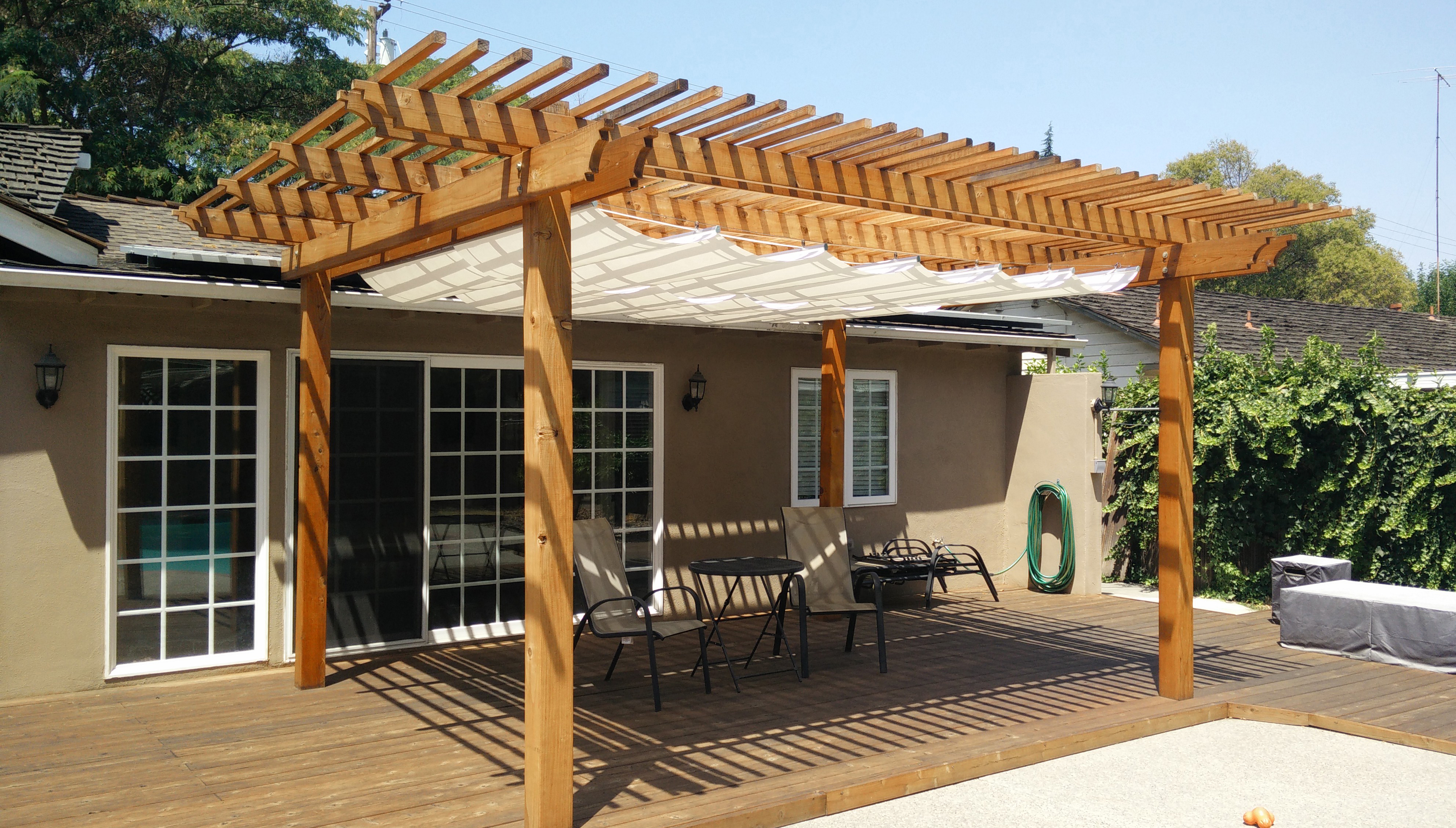 pergola and infinity canopy over a backyard patio